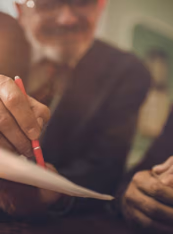 Hands signing a contract